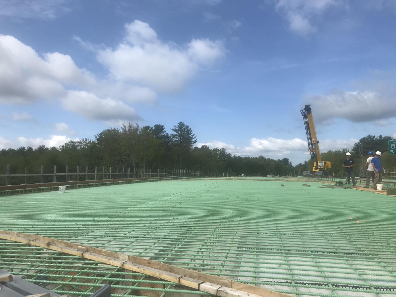 Reinforced bridge deck under construction beneath a broad sky