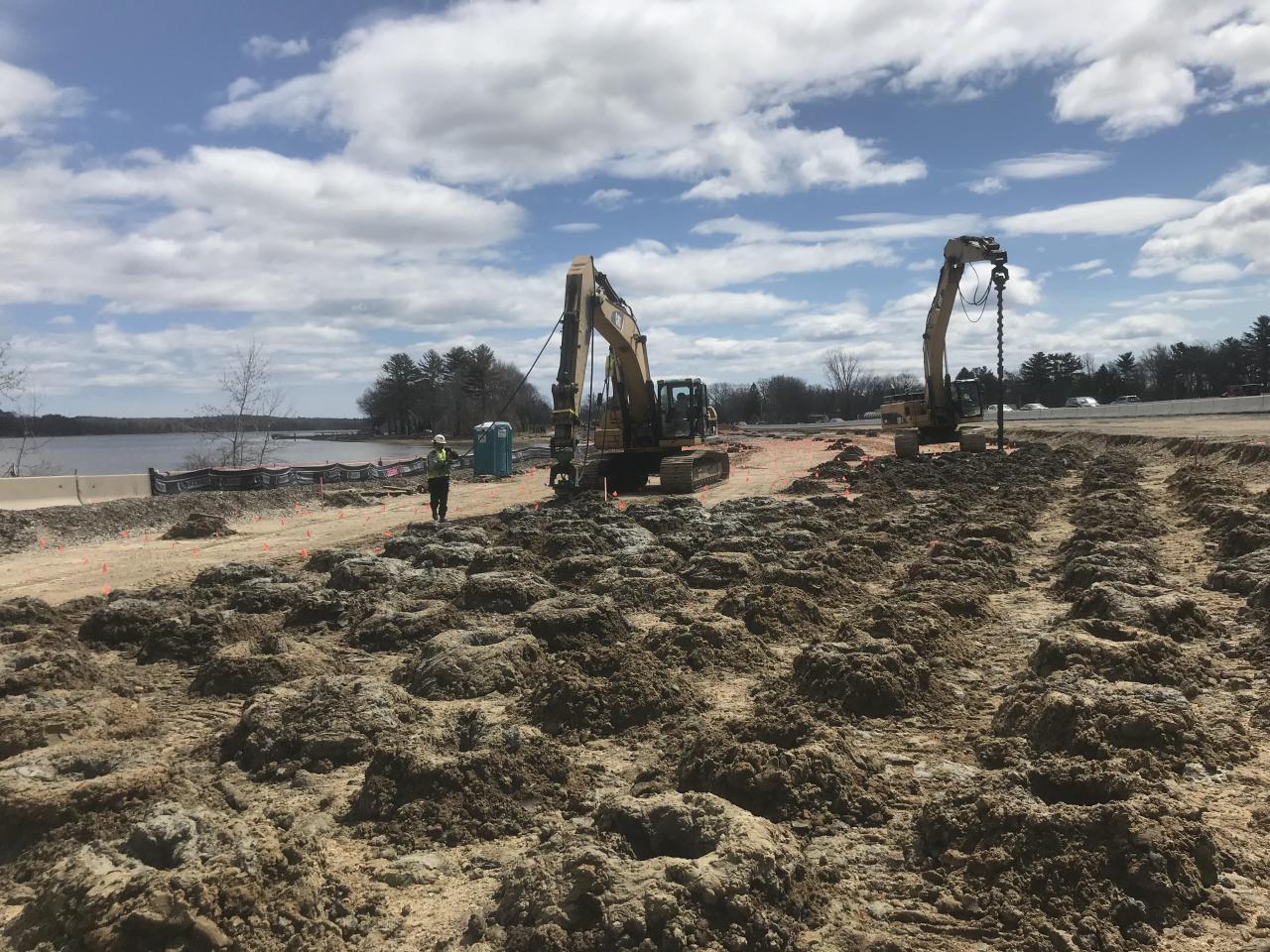 Excavators performing site and ground work near water